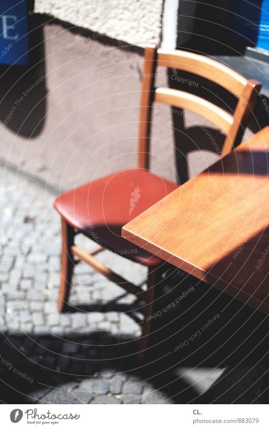 seating Wall (barrier) Wall (building) Chair Table Tabletop Cobblestones Sit 1 Colour photo Exterior shot Deserted Day Light Shadow Contrast