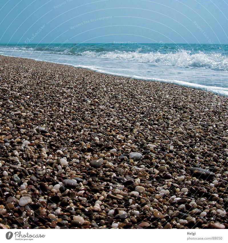 Pebble beach with surf on the Mediterranean Sea Colour photo Subdued colour Exterior shot Deserted Copy Space top Day Shadow Reflection Sunlight