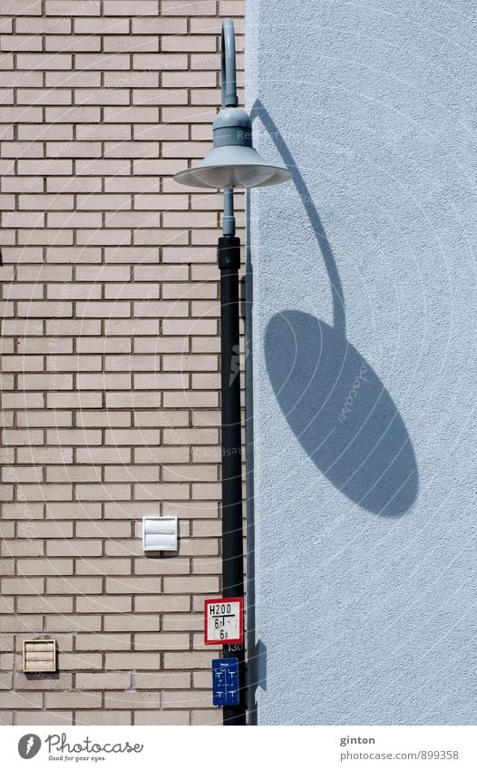 Lantern with shadow Street lighting Town House (Residential Structure) Manmade structures Building Architecture Wall (barrier) Wall (building) Facade Stone