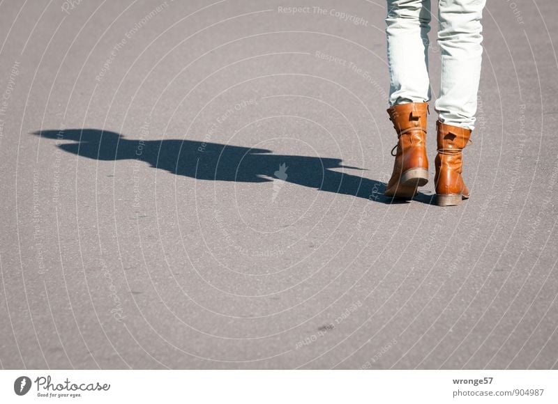 hiking day Trip Human being Feminine Woman Adults Legs 1 45 - 60 years Movement Going Brown Gray Rear view Pavement Asphalt Sunlight Shadow Shadow play Boots