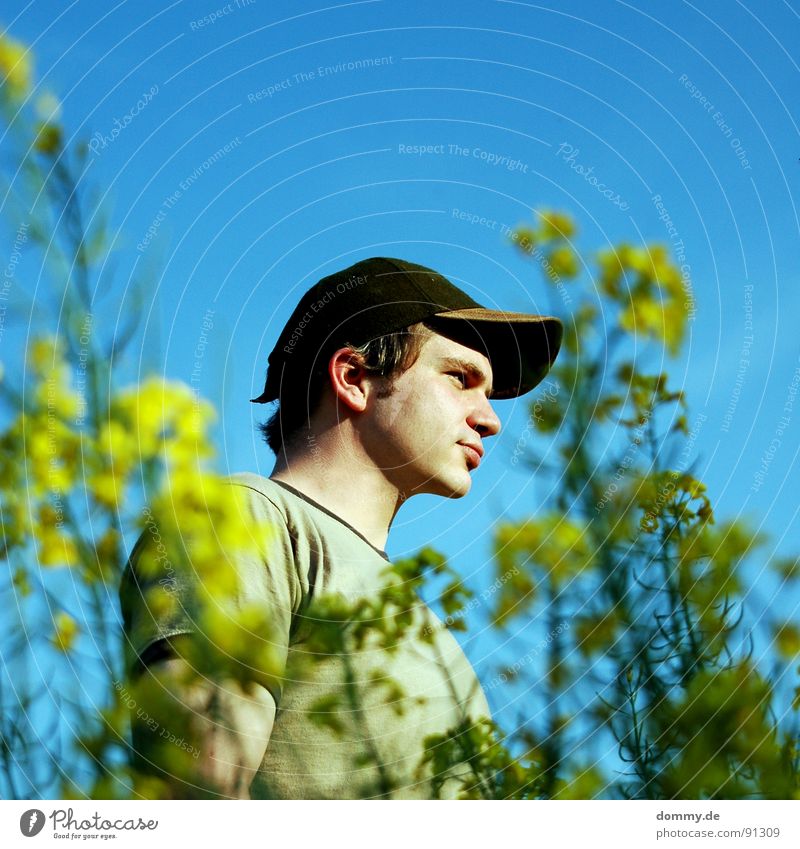 country boy Man Fellow Field Summer Physics Canola Baseball cap Facial hair Stopper Eyebrow Blossom Yellow Chin Shoulder Upper arm covenant claus Warmth