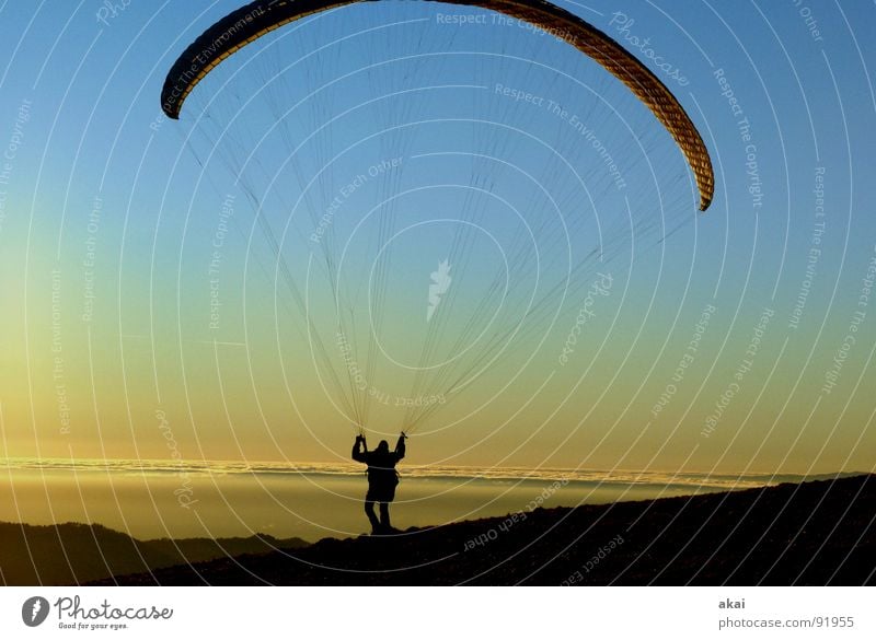 Paraglider at Schauinsland 2 Paragliding Play of colours Sky blue Romance Sunlight Sunbeam Sunset Departure Homey Evening Bronze Emotions Puppy love Orange