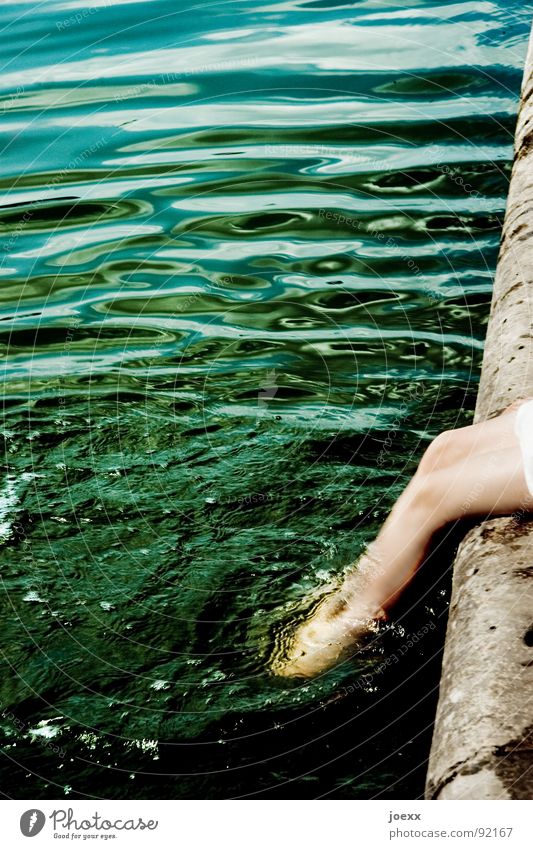 Making waves. Refrigeration Dark Refreshment Foot bath Dangerous Green Physics Young woman Corner Dress Knee Curls Circle Cooling Ocean Wet Promenade Edge Lake