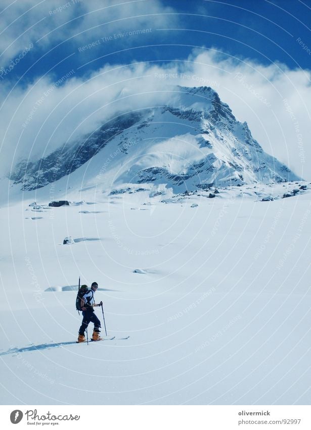 the first track Powder snow Ski tour Skier Snow track Clouds Moody Mountaineer Winter sports Blue sky Nature 4000s grand paradiso