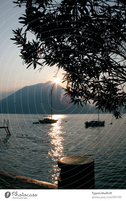 Lake with boat Watercraft Sunset Tree Footbridge Mountain Evening