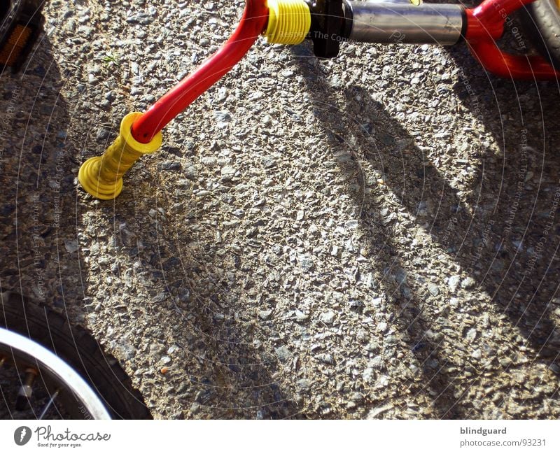 Accident in the schoolyard Bicycle Tricycle Concrete Door handle Summer Red Yellow Leisure and hobbies Transport bycicle Bicycle handlebars Spokes bemse Sun