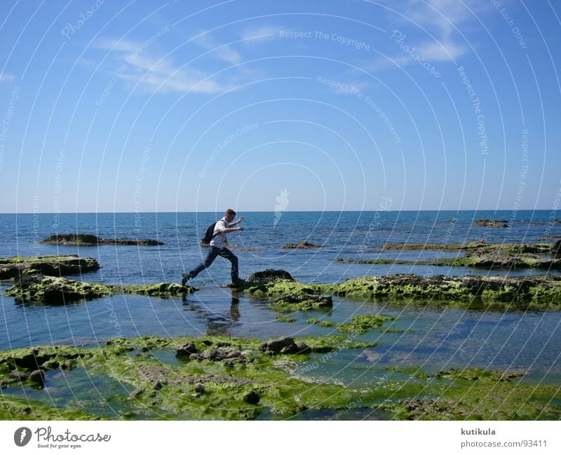 A small jump Man Jump Ocean Turkey Coast Backpack Loneliness Force Small Green Vacation & Travel Exterior shot Joy Success Safety Stone Blue Far-off places