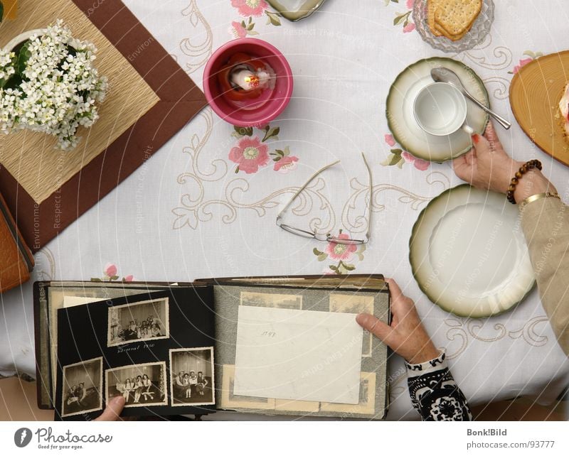 coffee-table gossip Grandmother Coffee break Cake Candle Flower Coffee table Memory Photo album Baked goods Historic Birthday crackers Black & white photo