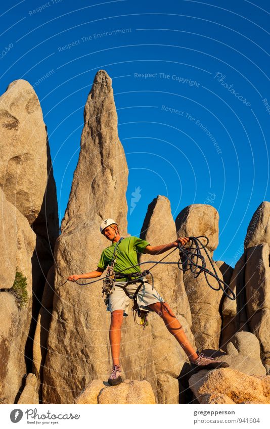 Climber celebrates on the summit. Adventure Climbing Mountaineering Success Rope 1 Human being 18 - 30 years Youth (Young adults) Adults Peak Helmet