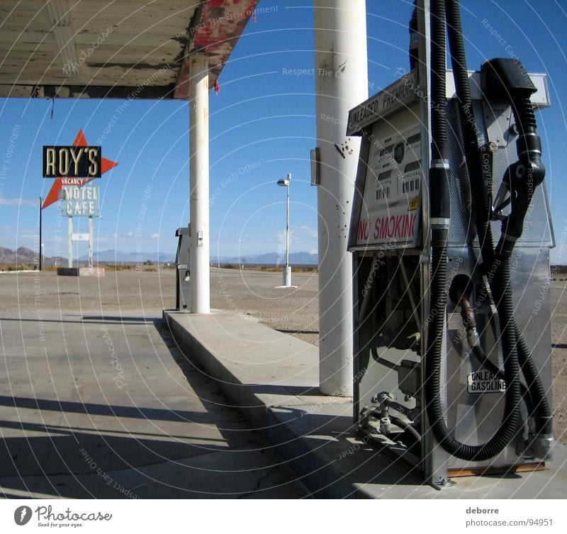 Retro American gas station on Route 66 with Roy's Motel sign in the background. Gasoline Raw materials and fuels Refuel Petrol station Americas Diesel Oil Gray