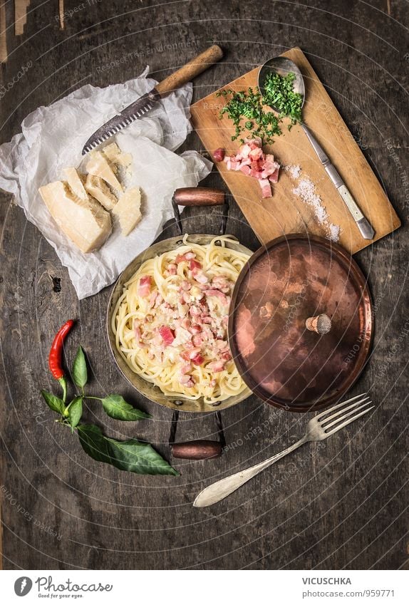 Spaghetti carbonara in a copper pot, served rustically Food Meat Sausage Dough Baked goods Soup Stew Herbs and spices Cooking oil Nutrition Lunch Dinner Banquet