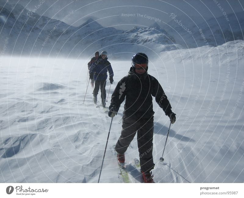 Ski tour over the ice Winter Skier Skiing Winter sports Frozen surface Snowstorm Snowdrift Hohen Tauern NP White Dangerous Cold Hard Wind Austria Exterior shot