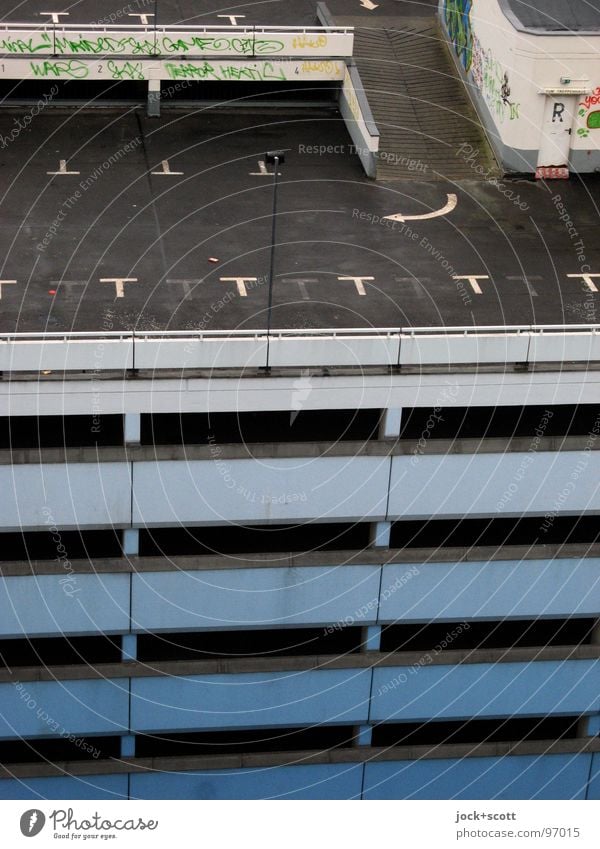 orphaned parking spaces on multi-storey car park II Parking garage Architecture Graffiti Arrow Tall Modern Gloomy Multi-story garage Ramp Garage Direction Rule