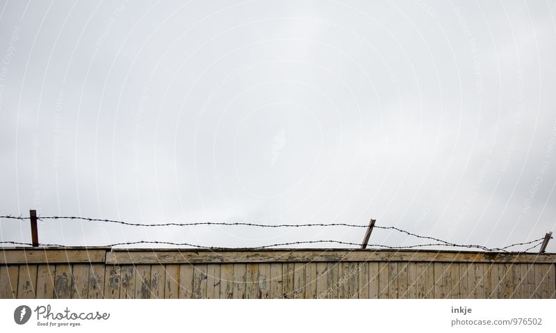 dreary, dreary, dreary Deserted Wall (barrier) Wall (building) Fence Wooden wall Barbed wire fence Thorny Gloomy Gray Emotions Moody Protection Bans Value