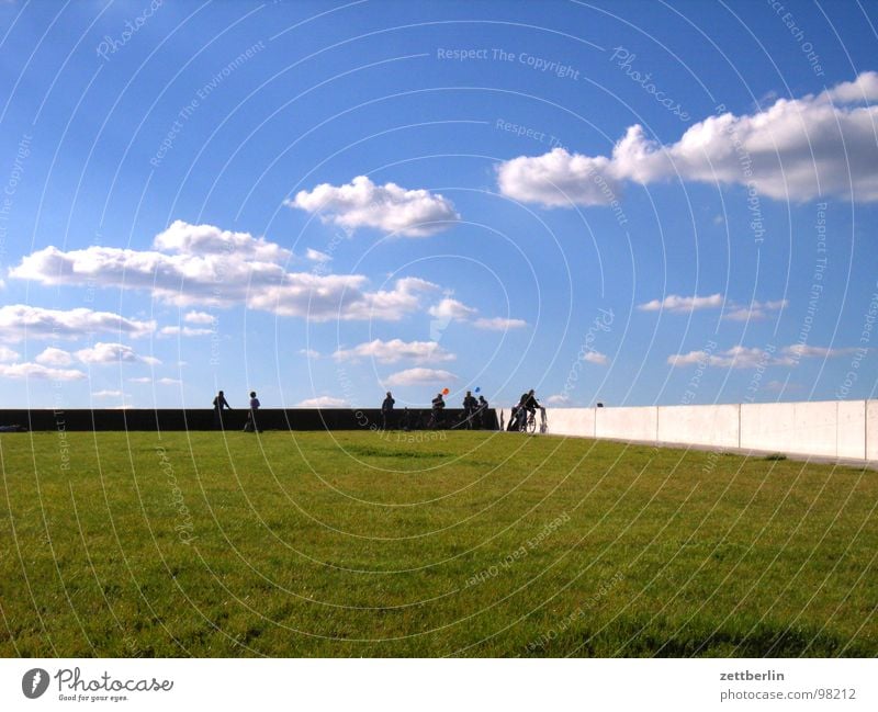 summer Summer Vacation & Travel Weekend Break Clouds Meadow Grass Green space Park Wall (building) Wall (barrier) Edge Handrail Human being Visitor Spreebogen