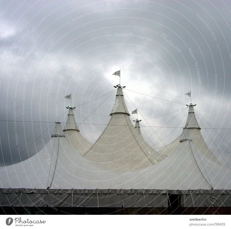 folk festival Fairs & Carnivals Peoples Clouds Cloud cover Gap in the clouds Tent Event Circus Circus tent Flag Flying the flag Gale Deep Low pressure zone