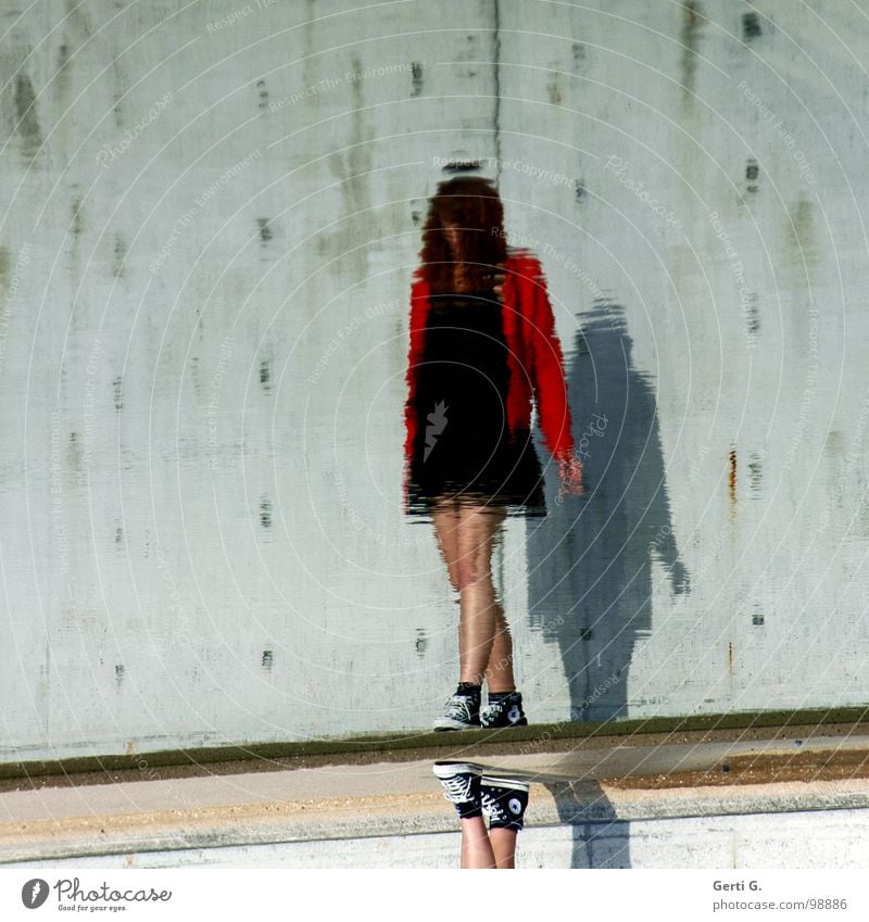 faceless Reflection Surface of water Distorted Woman Mini dress Black Little black dress Jacket Red Slowly Wall (barrier) Wall (building) Sky blue Green Gray