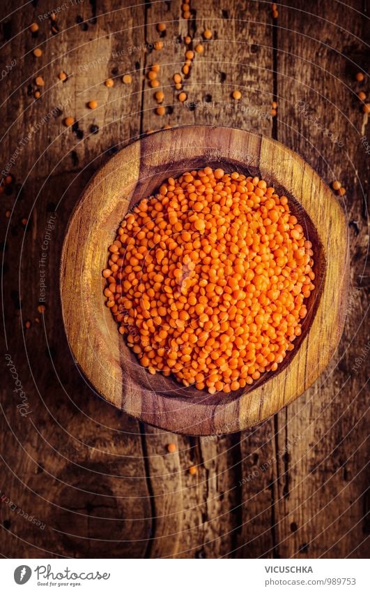 Red lenses in wooden bowl Food Grain Nutrition Style Design Life Yellow Protein Vegan diet Lentils Wooden table Rustic Brown Perspective Above Colour