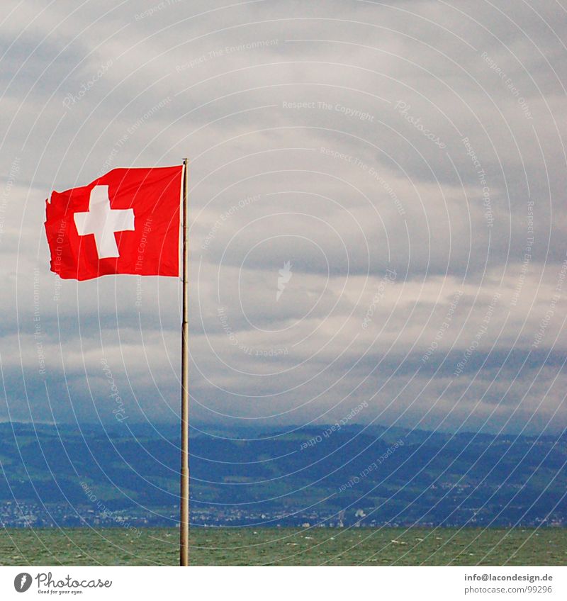 View of Switzerland Flag Clouds Friedrichshafen Judder Swiss Red Green Colour Europe Lake Constance Coast Wind flagpole Electricity pylon Back schwiz Blue