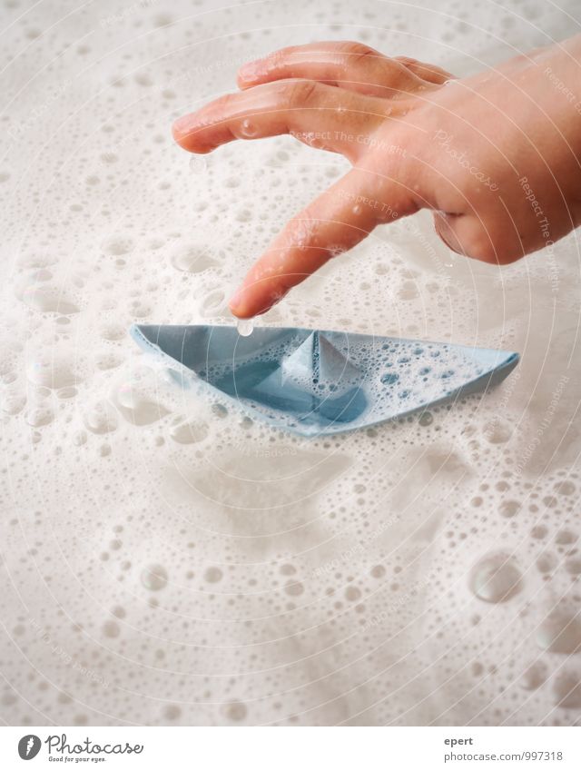 sinking ships Playing Children's game Paper boat Bathtub Hand Foam bath Water Swimming & Bathing Joy Infancy Colour photo Interior shot Close-up