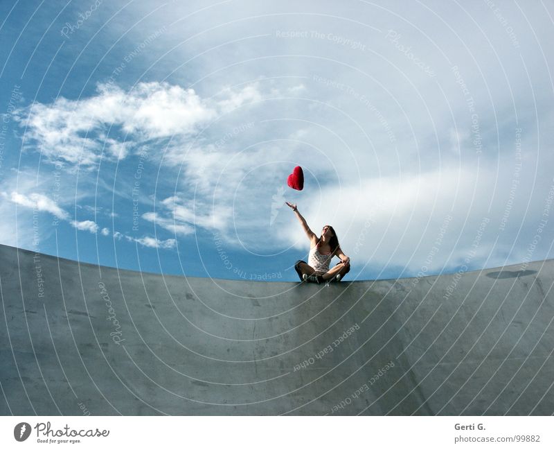 what goes up... Woman Young woman Catch Touch Bad weather Clouds Location Footwear Chucks Gray Red Flying Hover Symbols and metaphors Cushion Heart Decoration